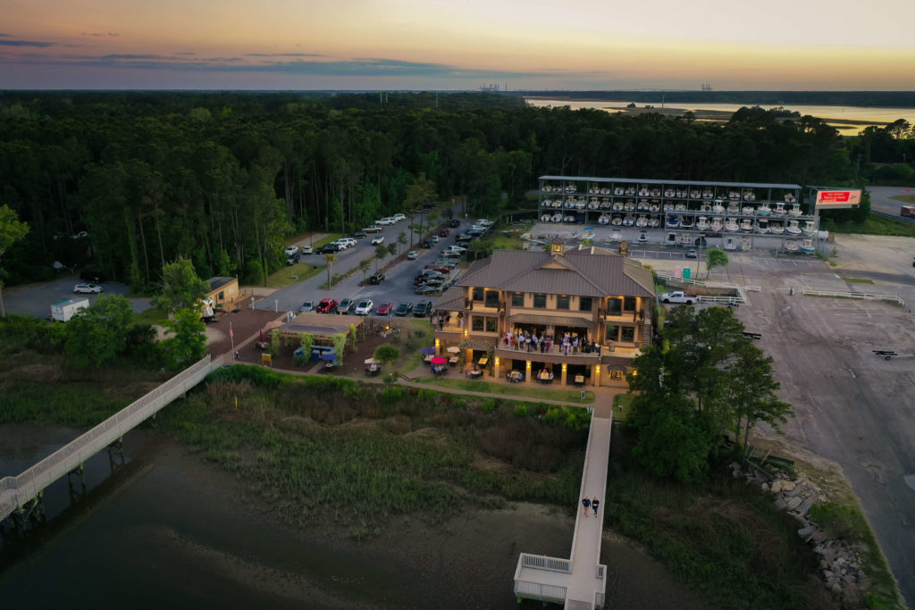 Drone photograph of aerial view of Wando River Grill in Charleston, South Carolina at sunset during a Charleston wedding.