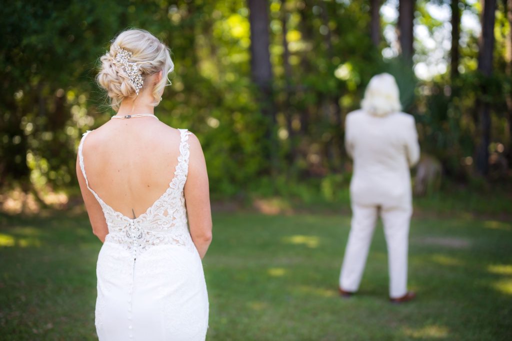Bride waits for her father to turn and see her in her wedding dress prior to Wando River Grill wedding ceremony.
