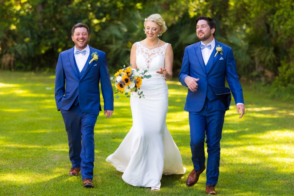 Bride laughs with her two brothers at her Wando River Grill wedding in Charleston, South Carolina.
